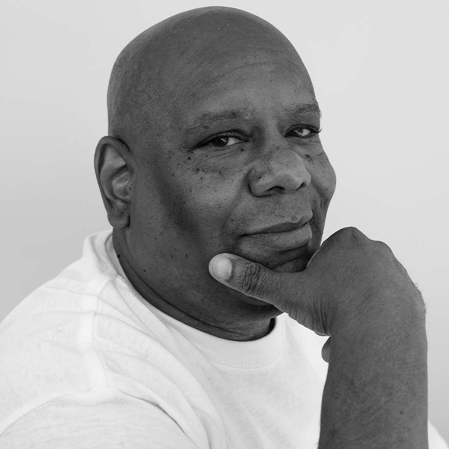 Black and white photograph of Shams DaBaron, an advocate fighting for dignified housing for people experiencing houselessness