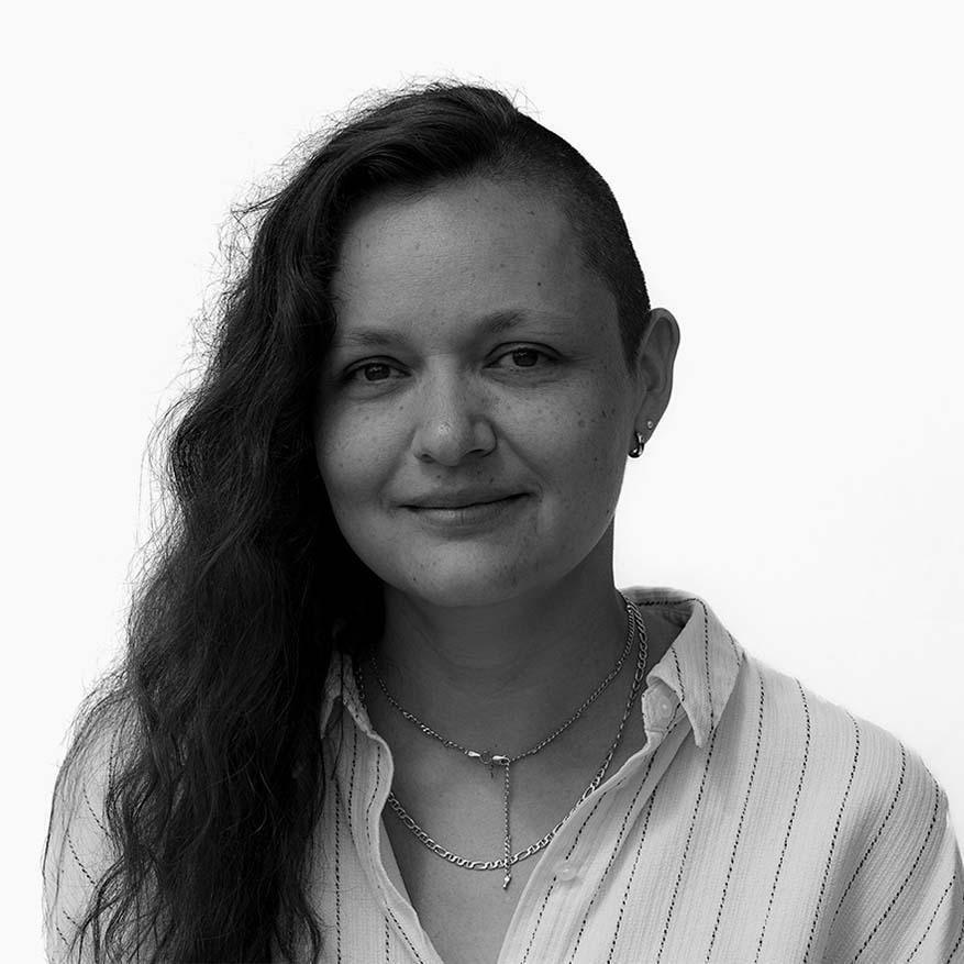 Black and white photo of Carmen Gama who is recovering, repairing, remanufacturing, and recycling the clothes New Yorkers throw away