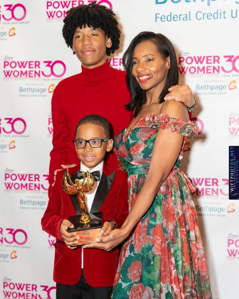 Image of Dianna and her sons at an award ceremony