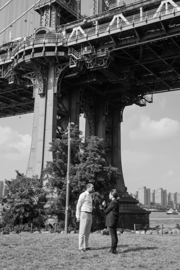 Erika Sasson standing under the Manhattan Bridge