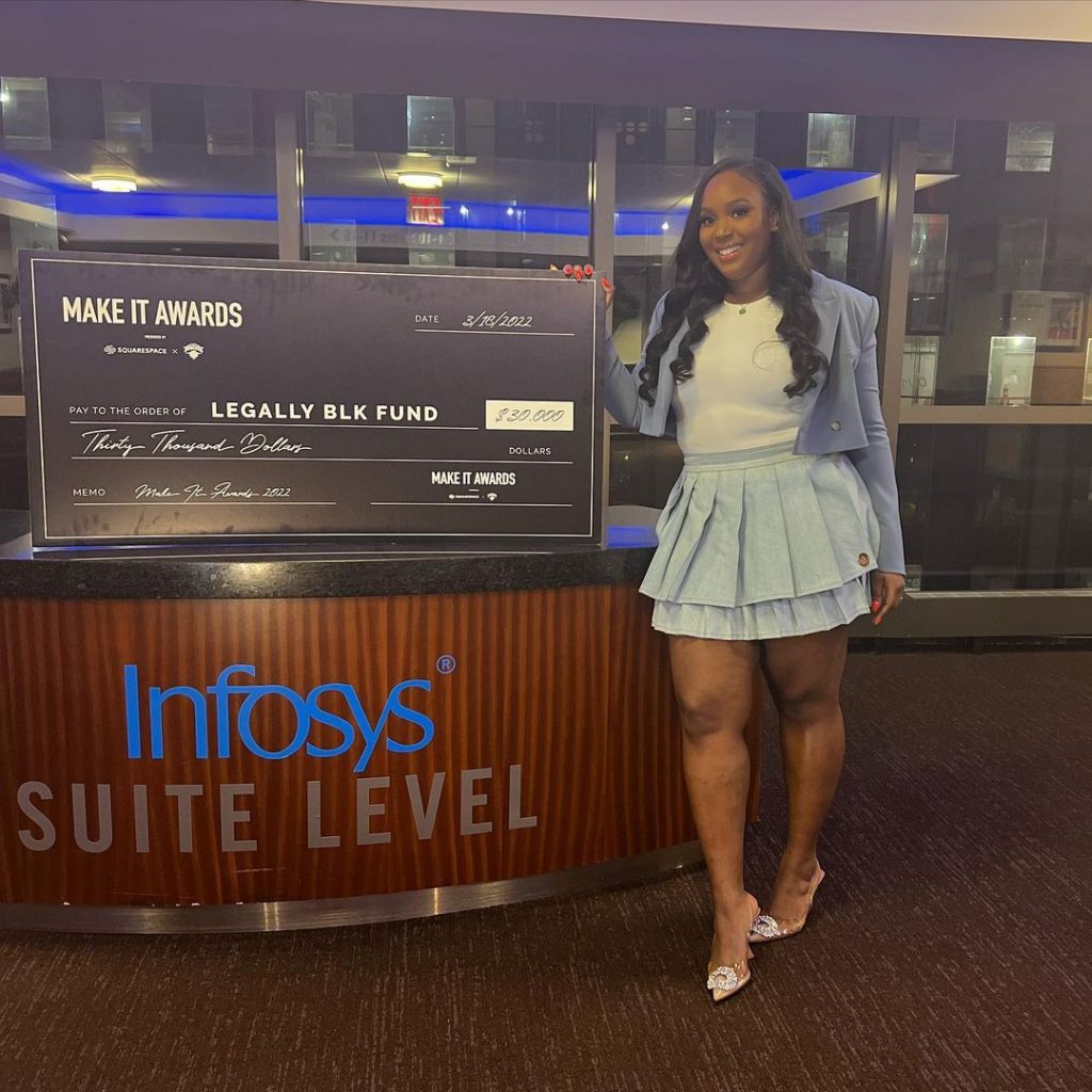 Image of Talia with a $30k donation to LBF